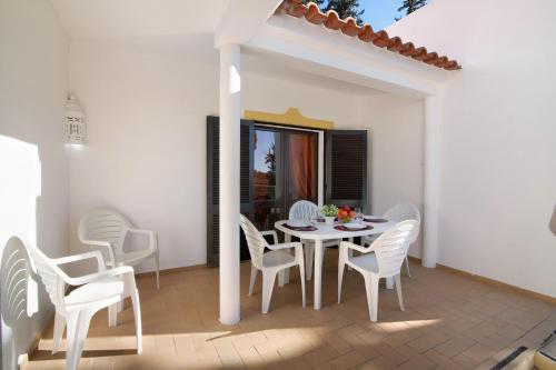a white table and chairs on a patio at Vila Filipa in Guia