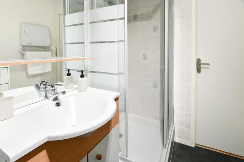 a bathroom with a sink and a shower at La Madély in Camiers