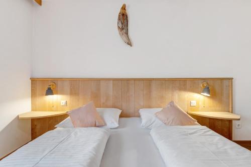 a bedroom with two beds and two lights on the wall at Apartment Stuflesser in Laion