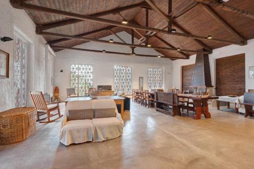 a large room with tables and chairs in a building at Agriturismo Monte Pu' in Castiglione Chiavarese