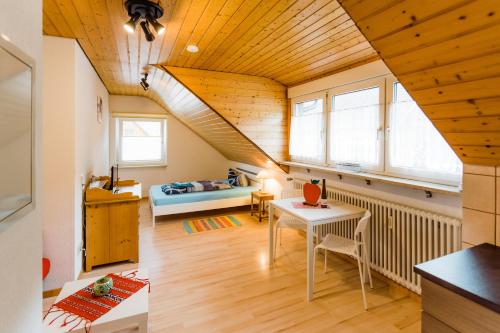 a room with a staircase with a table and a bed at Gala in Stockach