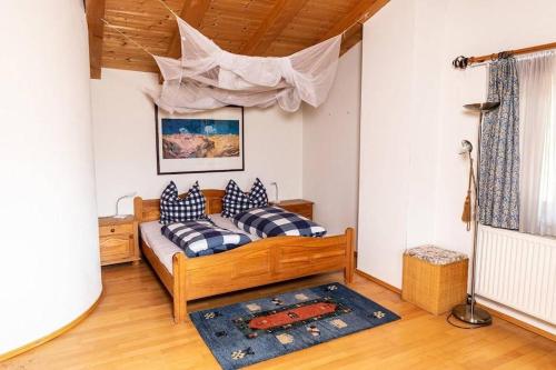 a bedroom with a bed with blue and white pillows at Haus Evelin in Kundl