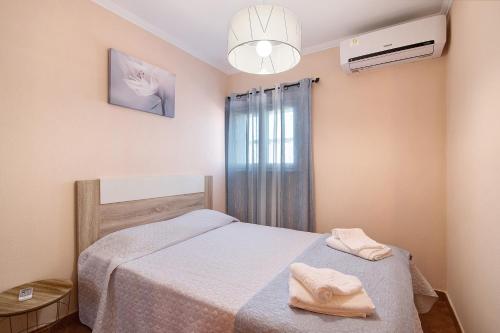 a small bedroom with a bed and a window at At-tunis in Tunes