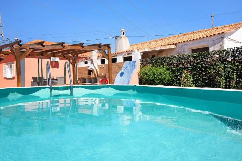 a swimming pool in front of a house at At-tunis in Tunes