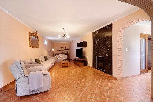 a living room with a couch and a fireplace at At-tunis in Tunes