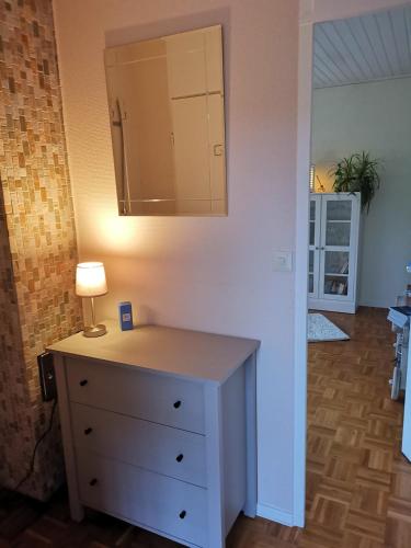 a dresser with a lamp on top of it in a room at Haus am Hennesee in Meschede