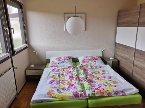 a bed with four pillows on it in a bedroom at Haus am Hennesee in Meschede