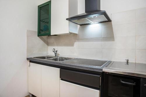 a kitchen with a sink and a stove at Martina's Place in Castello di Fiemme