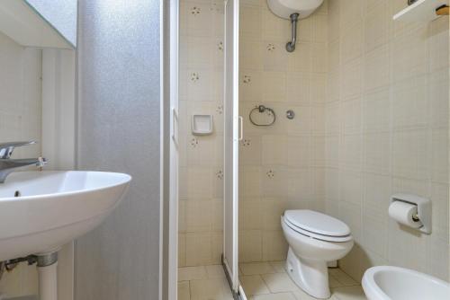 a bathroom with a toilet and a sink and a shower at Il Quadrifoglio 2 in Procchio