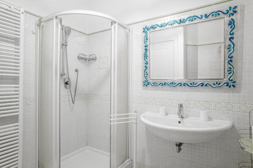 a white bathroom with a sink and a shower at Appartamento La Naiade, Lucca in Lucca