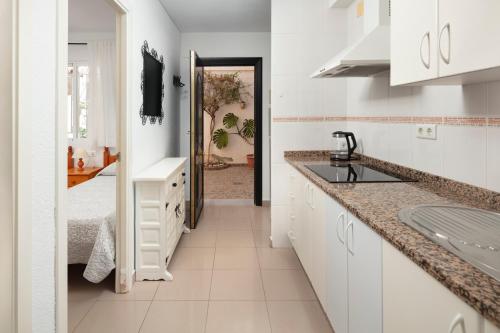 a kitchen with white cabinets and a sink at Apartamento M 1 in Torrox Costa