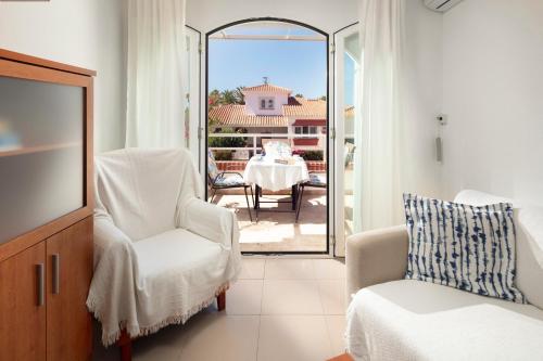 a living room with two chairs and a table on a patio at Apartamento M 1 in Torrox Costa