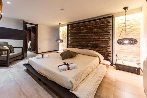 a bedroom with a large bed with a large window at Villa Rokkaria in Villasimius