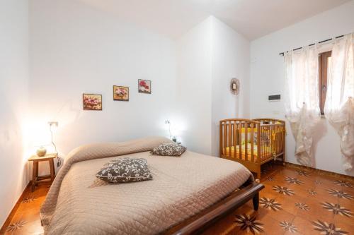 a bedroom with a bed with two pillows on it at Gaia Casa Vacanze in San Giovanni Suergiu