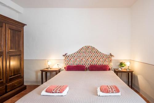 a bedroom with a bed with two pillows on it at Podere del Pereto Bio- 203 in Rapolano Terme