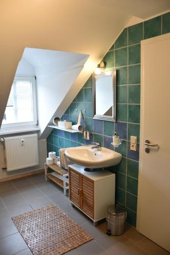 a bathroom with a sink and a mirror at Ferienwohnung Happynest in Birresborn