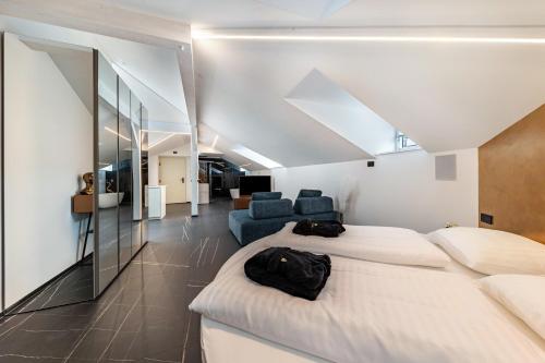 a bedroom with two beds and a living room at App 304 Palazzo Cavour in Bolzano