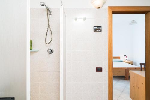 a shower with a glass door in a bathroom at Casa nel centro di Budoni in Budoni