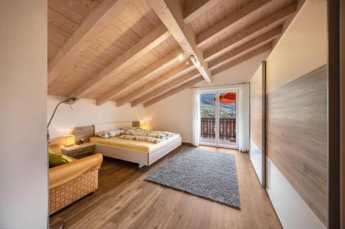 a bedroom with a bed and a large window at Panoramawohnung Annaheim in Rifiano