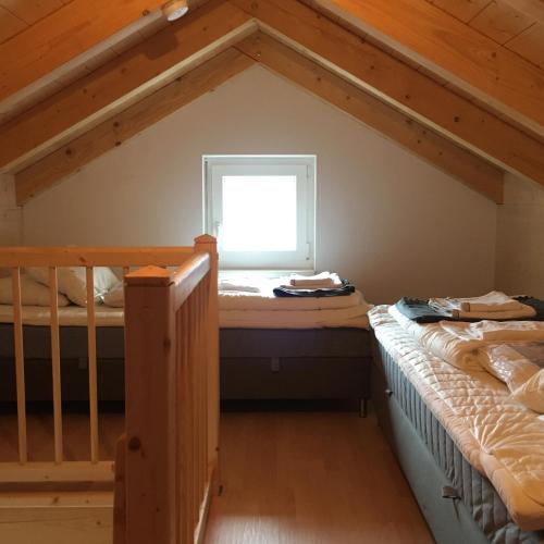 a bedroom with two bunk beds and a window at Ferienhaus Seltschach 193 in Arnoldstein