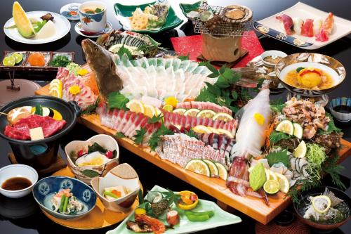 a table topped with lots of different types of food at Ikijimaso in Iki