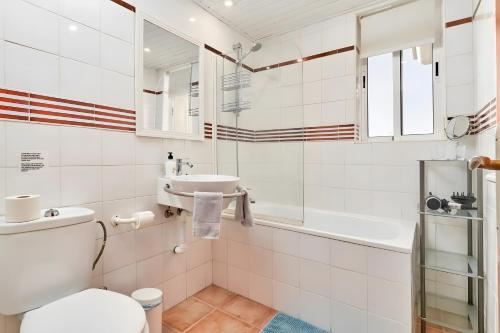 a bathroom with a toilet and a sink at Villa Estrella de Cotobro in Almuñécar
