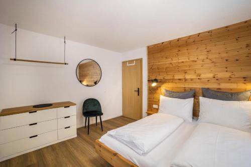 a bedroom with a large bed with a wooden headboard at Mountain Residence Kasern Nr 2 in Predoi