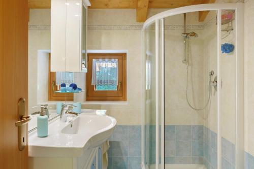 a bathroom with a sink and a shower at Chalet Camillo in Moline