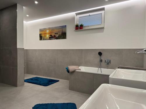 a bathroom with a tub and a sink at Berg und Meer in WÃ¶lpinghausen