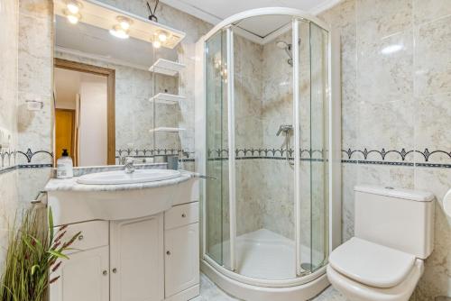 a bathroom with a shower and a toilet and a sink at Sol Mar Arzuaga in Jávea