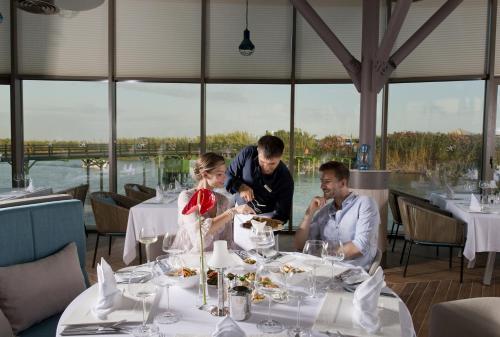 a man and woman sitting at a table with plates of food at Xanadu Resort Hotel - High Class All Inclusive in Belek