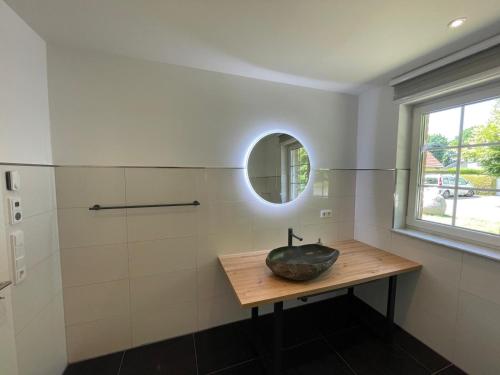 a bathroom with a sink and a mirror at Ferienhaus Rechlin in Rechlin