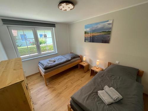 a bedroom with a bed and a futon in it at Ferienhaus Rechlin in Rechlin
