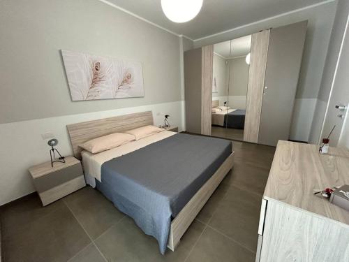 a bedroom with a bed and a large mirror at Lungomare Santa Caterina in Nardò