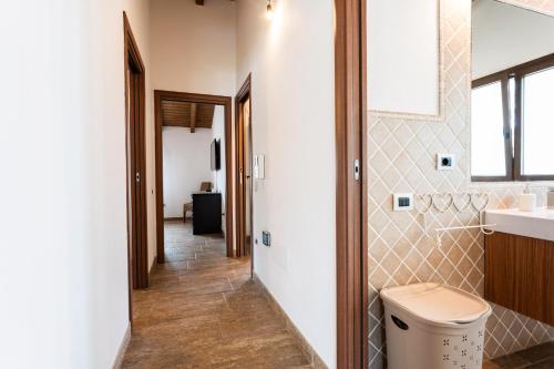 a hallway of a bathroom with a sink and a toilet at Villa Harmony in Quartu SantʼElena