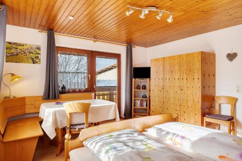 a bedroom with a bed and a table and a window at Ignazhof in Horben