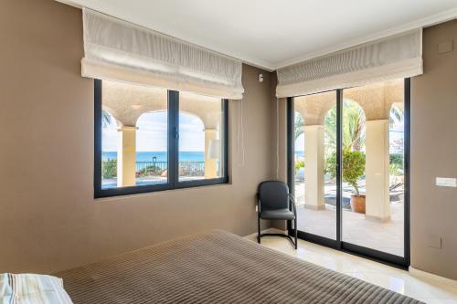 a bedroom with a bed and a view of the ocean at Villa Mara in El Campello