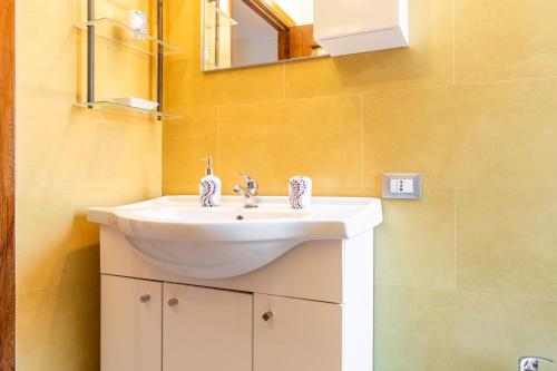 a bathroom with a white sink and a mirror at Magy House in Quartu SantʼElena