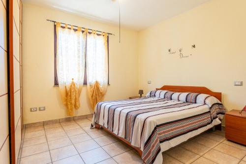 a bedroom with a bed and a window at Magy House in Quartu SantʼElena