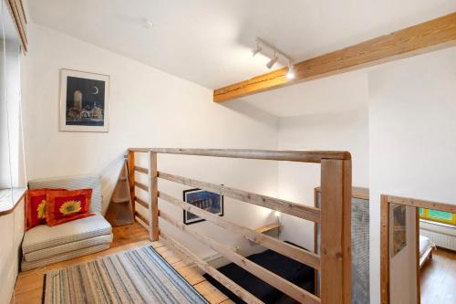 a staircase in a room with white walls and wooden floors at Ferienhaus Poggenkrug Halbsguth in Wolgast