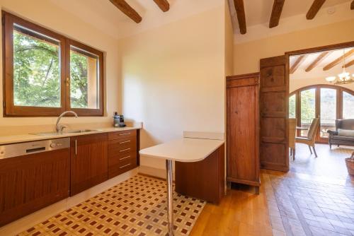 a kitchen with a sink and a table in a room at Casa Argentera Full House in Argentera