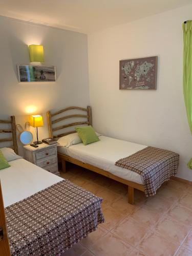 a room with two beds in a room at Chalet con piscina en Menorca in Cala en Bosc