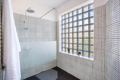a bathroom with a shower and a glass shower backdoor at Mother's House in Calheta