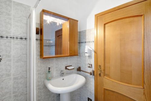 a bathroom with a sink and a mirror at Residence Malibu Appartamento 2 in Falcade