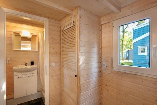 a bathroom with a sink and a window at Tiny House Nr 1 in Schwielowsee