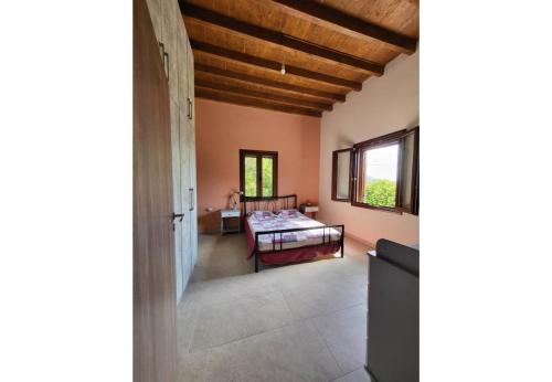 a bedroom with a bed in a room at Villa Two Pine Trees in Alinda