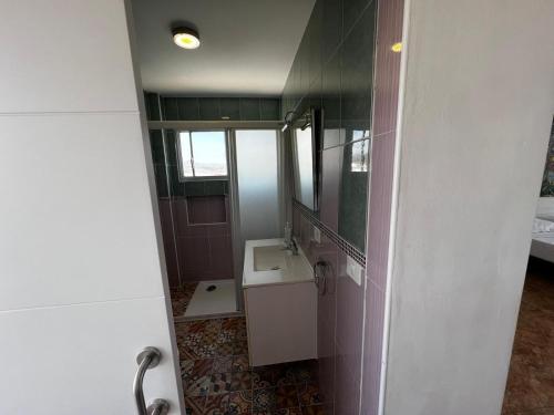 a bathroom with a sink and a mirror at Loft Molinos Corner in San Bartolomé