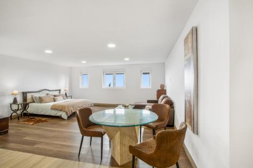 a living room with a glass table and chairs at Bastion del Drago in Arucas