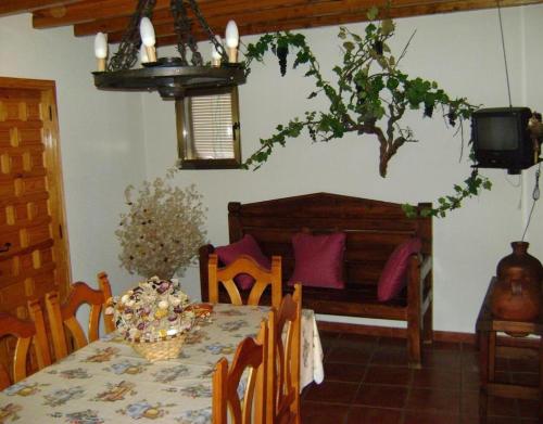 a dining room with a table and a couch at Casa Lopez San Martín in San Martín del Castañar