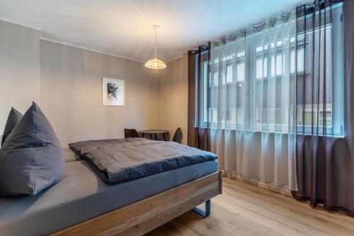 a bedroom with a bed and a large window at Im Rosengarten 2 in Zell am Harmersbach